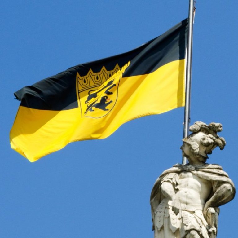 Die Flagge von Baden-Württemberg mit einem Löwen und einer Krone auf blauem Hintergrund.
